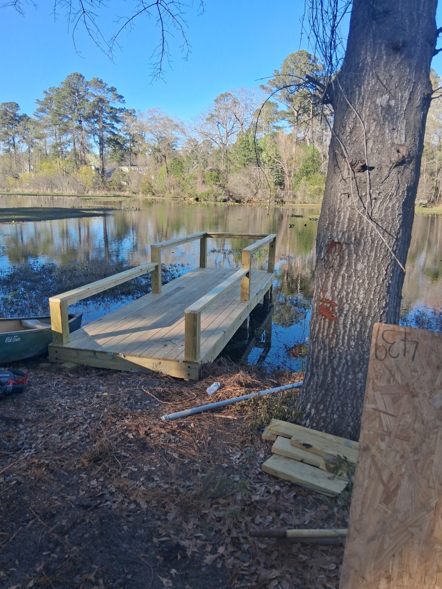 Finished wooden dock by the pond